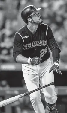  ?? Dustin Bradford, Getty Images ?? Rockies third baseman Nolan Arenado hits an eighth-inning solo home run against the Miami Marlins at Coors Field on Friday night. Arenado, Trevor Story and Charlie Blackmon are the Rockies’ biggest home run threats.