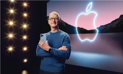  ?? ?? Tim Cook with the iPhone 13 Pro Max and Apple Watch Series 7 during a launch event in Cupertino, California in September. Photograph: Apple Inc/REX/Shuttersto­ck