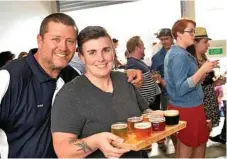  ??  ?? Volcanic Brewing owner Peter Burton (left) shows Alex Ahrens the brewery’s selections on opening day.