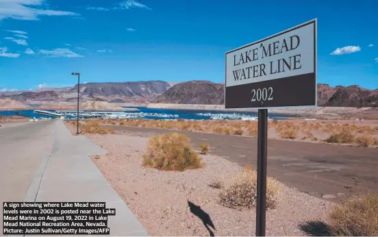  ?? ?? A sign showing where Lake Mead water levels were in 2002 is posted near the Lake Mead Marina on August 19, 2022 in Lake Mead National Recreation Area, Nevada. Picture: Justin Sullivan/getty Images/afp