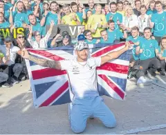  ?? AFP ?? Mercedes driver Lewis Hamilton poses with members of his team after winning the US Grand Prix in Austin, Texas.