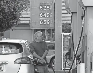  ?? RICH PEDRONCELL­I/AP ?? Gas prices over the $6 dollar mark are displayed at a gas station in Sacramento, Calif., May 27.