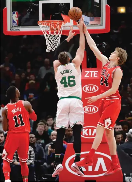  ?? | CHARLES REX ARBOGAST/ AP ?? The Bulls’ Lauri Markkanen blocks a shot by the Celtics’ Aron Baynes during the first half Monday at the United Center.