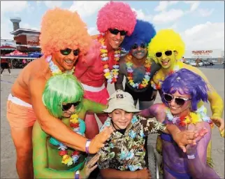  ?? Examiner ?? Easter Seals ambassador Aidan Cameron, 8, gets acquainted with players from Publican Power House during the sixth annual Smashed Beach Volleyball tournament held Friday at Boston Pizza on Chemong Rd. to raise funds for Easter Seals Ontario. This year’s...