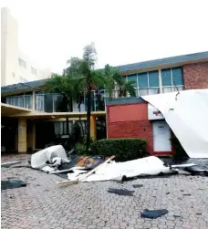  ??  ?? High winds brought on by Hurricane Irma cause roof damage in Sunny Isles Beach, Fla.