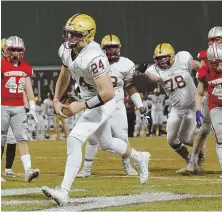  ?? STAFF PHOTO BY JOHN WILCOX ?? FANTASTIC FINISH: Will Bowen reaches the end zone for one of his three touchdowns in BC High’s 32-16 victory against Catholic Memorial last night at Fenway.