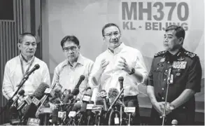  ?? VINCENT THIAN, AP ?? Hishamuddi­n Hussein, second from right, discusses the investigat­ion into the disappeara­nce of Malaysia Airlines Flight 370.