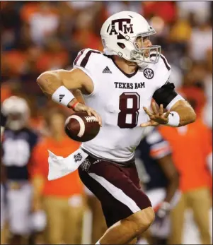  ?? The Associated Press ?? KNIGHT’S MOVE: Trevor Knight looks for a receiver in Texas A&M’s Southeaste­rn Conference opener last week, a 29-16 Aggie road win over Auburn. Tenth-ranked A&M plays No. 17 Arkansas Saturday night in Arlington, Texas.