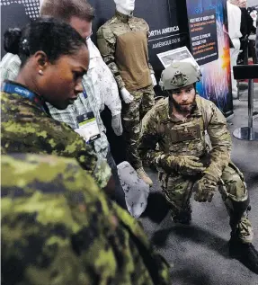  ?? JUSTIN TANG / THE CANADIAN PRESS ?? Simon Forget of Mawashi demonstrat­es the UPRISE tactical exoskeleto­n at the Canadian Associatio­n of Defence and Security Industries Cansec trade show in Ottawa on Wednesday.