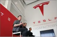  ?? AP PHOTO BY RICH PEDRONCELL­I ?? In this 2016, file photo, Elon Musk, CEO of Tesla Motors Inc., left, discusses the company’s new Gigafactor­y in Sparks, Nev. Shareholde­rs of electric car and solar panel maker Tesla Inc. are voting on a pay package for Musk that could net him more than...