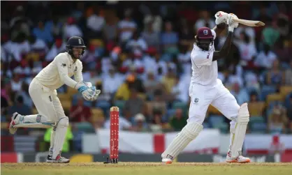  ??  ?? Ben Foakes can only watch on as Jason Holder compiles his matchwinni­ng unbeaten double century for West Indies in Barbados. Photograph: Shaun Botterill/Getty Images
