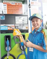 ??  ?? A Bangchak employee provides E20 blend at the company’s station on Sukhaphiba­n 1 Road.