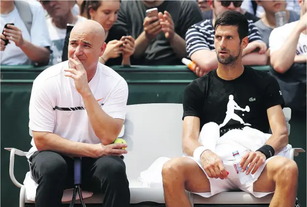  ?? JULIAN FINNEY / GETTY IMAGES ?? Novak Djokovic, right, has hired Andre Agassi as part of his bid to become the first man in the Open era to win each of the four majors twice.