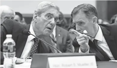  ?? SUSAN WALSH/AP ?? Former special counsel Robert Mueller, left, talks with aide Aaron Zebley during a House Judiciary Committee hearing on Wednesday in Washington.