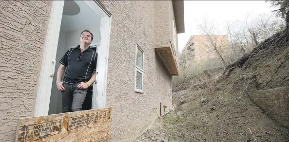  ?? LIAM RICHARDS ?? Kent Rathwell stands at his back door where he once had a deck prior to the a slope failure that has made his home uninhabita­ble. Meanwhile his taxes have been increasing.