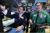  ?? RICHARD DREW — THE ASSOCIATED PRESS ?? Specialist Peter Mazza, left, and trader Ryan Falvey work on the floor of the New York Stock Exchange, Thursday. Stocks are slumping in early trading on Wall Street led by steep drops in Macy’s and other retailers after several of the companies reported weak holiday sales.