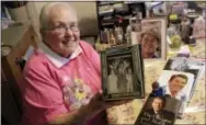  ?? RICHARD DREW — THE ASSOCIATED PRESS ?? Former Ronald Reagan Internatio­nal Fan Club president Zelda Multz, 89, poses for photos with Reagan memorabili­a in her apartment in the Brooklyn borough of New York. Long before he was president of the United States or even governor of California,...