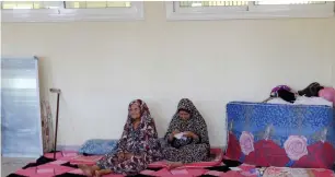  ?? (Ismail Zitouny/Reuters) ?? MABROUKA AL-TWATI, an 80-year-old displaced woman from Libya, sits with her daughter Tabra al-Hamali in a school used as a shelter in Tripoli earlier this month.