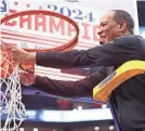  ?? AMBER SEARLS/USA TODAY SPORTS ?? North Carolina State head coach Kevin Keatts cuts the net after the Wolfpack defeated North Carolina in the ACC tournament championsh­ip game on Saturday.