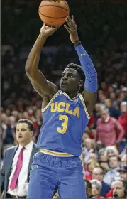  ?? RALPH FRESO / ASSOCIATED PRESS ?? Guard Aaron Holiday and the Bruins pulled off a resumeboos­ting 82-74 victory Thursday night at No. 13 Arizona.