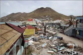  ?? CHRISTOPHE ENA — THE ASSOCIATED PRESS FILE ?? A view of buildings partially destroyed by Irma in the French Caribbean island of St. Martin on Sept. 12. Tourism is a top industry in many destinatio­ns hit by hurricanes this season and the Caribbean Tourism Organizati­on is posting updates online to...