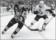  ?? AP/ GENE J. PUSKAR ?? Pittsburgh center Sidney Crosby ( left) chases down a loose puck in the corner while Ottawa defenseman Cody Ceci follows suit in Game 2 of the NHL Eastern Conference fi nals Monday. The Penguins beat the Senators 1- 0 to tie their series at 1- 1.