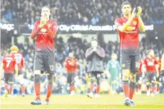  ??  ?? Manchester United’s English defender Chris Smalling (L) and Manchester United’s English striker Marcus Rashford applaud fans after losing the English Premier League football match between Manchester City and Manchester United at the Etihad Stadium in Manchester, north west England, on November 11, 2018. - AFP photo