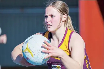  ??  ?? Macy Newcombe takes a second to assess her options for the Drouin Hawks as they look to maintain possession in the under 17 game.