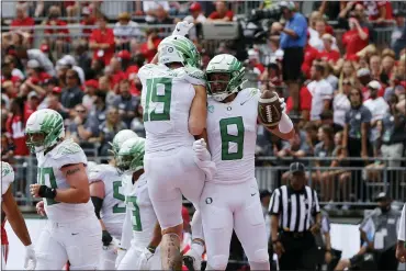  ?? JAY LAPRETE — THE ASSOCIATED PRESS ?? Oregon tight end Moliki Matavao, right, celebrates his touchdown against Ohio State with tight end Terrance Ferguson during the second half of an NCAA college football game Saturday, Sept. 11, 2021, in Columbus, Ohio. Oregon beat Ohio State 35-28.