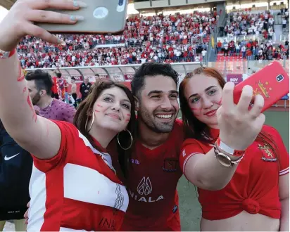  ??  ?? Young Valletta female fans celebrate by cuddling their "hero" Rowen Muscat through a selfie photo. ALL Photos: Domenic Aquilina