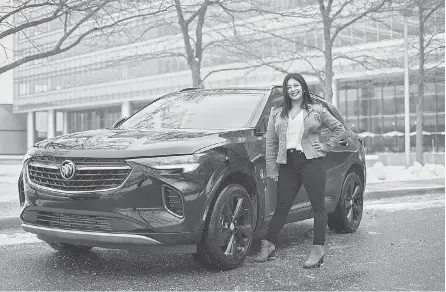  ?? RYAN GARZA/ USA TODAY NETWORK ?? General Motors Senior Design Release Engineer Sandya Jackson with a 2021 Buick Envision ST at the General Motors Tech Center in Warren, Mich. Jackson is part of a team of engineers and marketers that have designed the Buick brand and its cars to appeal to women. As a result, Buick leads in female buyers across all brands.