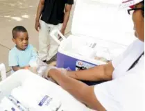  ?? ESSDRAS M SUAREZ/GLOBE STAFF ?? Branden Varilus, 3, of Somerville, was among 243 children who received a free meal outside of the Franklin Park.