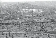  ??  ?? In this Feb. 20 photo, oil field infrastruc­ture dominates the landscape at the densely developed Kern River oil field just outside of Bakersfiel­d, Calif. [JAY CALDERON/ THE DESERT SUN VIA USA TODAY NETWORK]