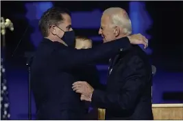  ?? ANDREW HARNIK — THE ASSOCIATED PRESS ?? President-elect Joe Biden, right, embraces his son Hunter Biden, left, in Wilmington, Del., on Nov. 7.