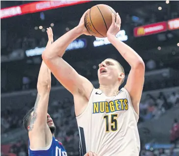  ?? AP ?? Nuggets centre Nikola Jokic shoots over Clippers guard Austin Rivers during the first half.