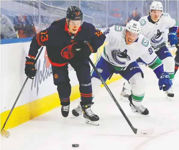  ?? USA TODAY SPORTS ?? Vancouver blueliner Nate Schmidt pursues Edmonton's Jesse Puljujarvi on Thursday in the second Canucks-Oilers game in two nights.