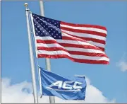  ?? Noah Syverson / Rome News-Tribune ?? The ACC flag billows right under the American flag Tuesday at the Rome Tennis Center at Berry College.