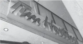  ?? EDUARDO LIMA/THE CANADIAN PRESS ?? The owners of a least 12 Tim Hortons outlets are rescinding perks and paid breaks. Tim Hortons head office said the actions of a “rogue group” do not reflect the views of the company.