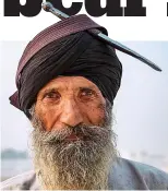  ??  ?? Armed: A Sikh pilgrim in Punjab with a kirpan dagger in his turban