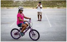  ??  ?? Pilar Rivera rides a bike by herself while her mom, Phyllis Mendoza, records a video.