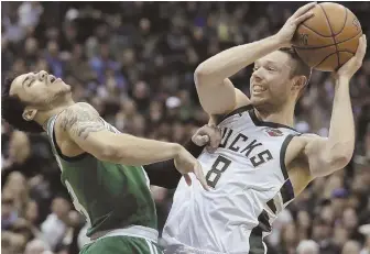  ?? AP PHOTOS ?? ROUGHED UP: Shane Larkin takes an elbow from the Bucks’ Matthew Dellavedov­a during the Celtics’ 116-92 loss in Game 3 last night in Milwaukee; below, Eric Bledsoe celebrates during the first half.