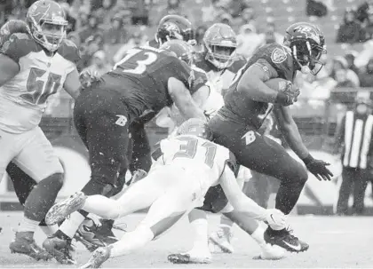  ?? KARL MERTON FERRON/BALTIMORE SUN ?? Ravens running back Gus Edwards breaks free of Buccaneers safety Jordan Whitehead (31) for a touchdown during the third quarter. The Ravens rushed for 242 yards Sunday, the fourth time they’ve cleared 200 in the past five games.