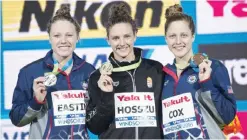  ??  ?? WINDSOR: Gold medalist Katinka Hosszu of Hungary shows off her medal along with silver medalist Ella Eastin, left, and bronze medalist Madisyn Cox during medal ceremonies for the women’s 200-meter individual medley at the FINA World Swimming...