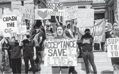  ?? Christophe­r Lee / New York Times ?? Demonstrat­ors protest March 1 at the Capitol over Texas’ policy that regards gender-affirming treatments for transgende­r youths as child abuse. The author notes the physical and psychologi­cal damage resulting from withholdin­g care.