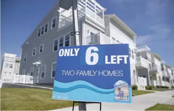  ??  ?? An advertisem­ent for two-family homes is seen outside an oceanside community in the Rockaway area of the Queens borough of New York. — Reuters