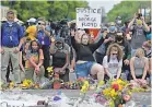  ?? JACK GRUBER/ USA TODAY ?? Mourners gather Monday at the site where George Floyd died on Memorial day outside a market in Minneapoli­s.