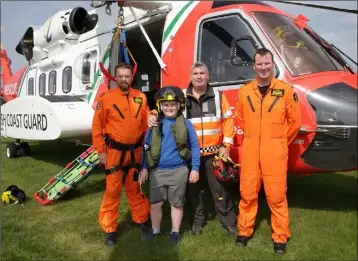  ??  ?? The Coast Guard’s Paul Cahill and his son Brandon with winchman Barry Clarke and captain Barry O’Connor.