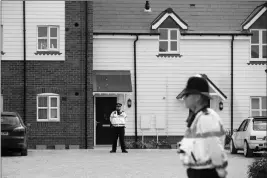  ?? ASSOCIATED PRESS ?? BRITISH POLICE OFFICERS STAND OUTSIDE A RESIDENTIA­L PROPERTY in Amesbury, England, on Wednesday. British police have declared a “major incident” after two people were exposed to an unknown substance in the town, and are cordoning off various places the...