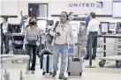  ??  ?? Passengers wearing face masks at Tampa Internatio­nal Airport, Florida