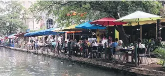  ?? MICHELE JARVIE ?? Casa Rio is a landmark on the San Antonio River Walk with its bright umbrellas. It opened in 1946, making it the oldest restaurant on the famous walk, which is a hub for tourism.